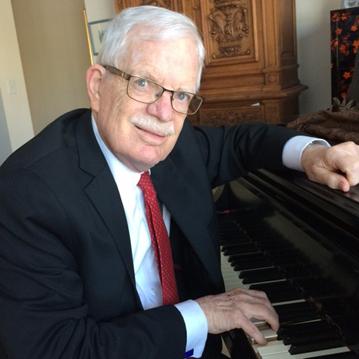 William sitting at a piano.